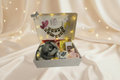Birthday Hamper on Cream Backdrop with Fairy Lights